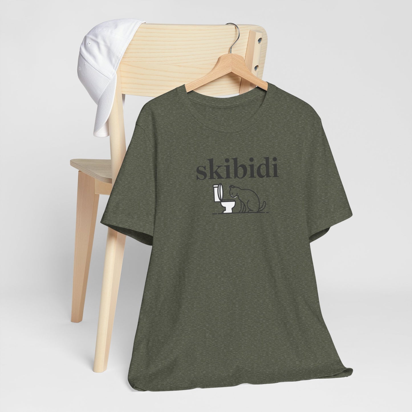 Funny Skibidi Toilet Cat Shirt Turn heads and spark laughter with our hilarious "Skibidi" T-shirt! Featuring a mischievous cat inspecting a toilet, this design is the perfect blend of quirky cat humor and minimalist style. Whether you're a cat lover, meme