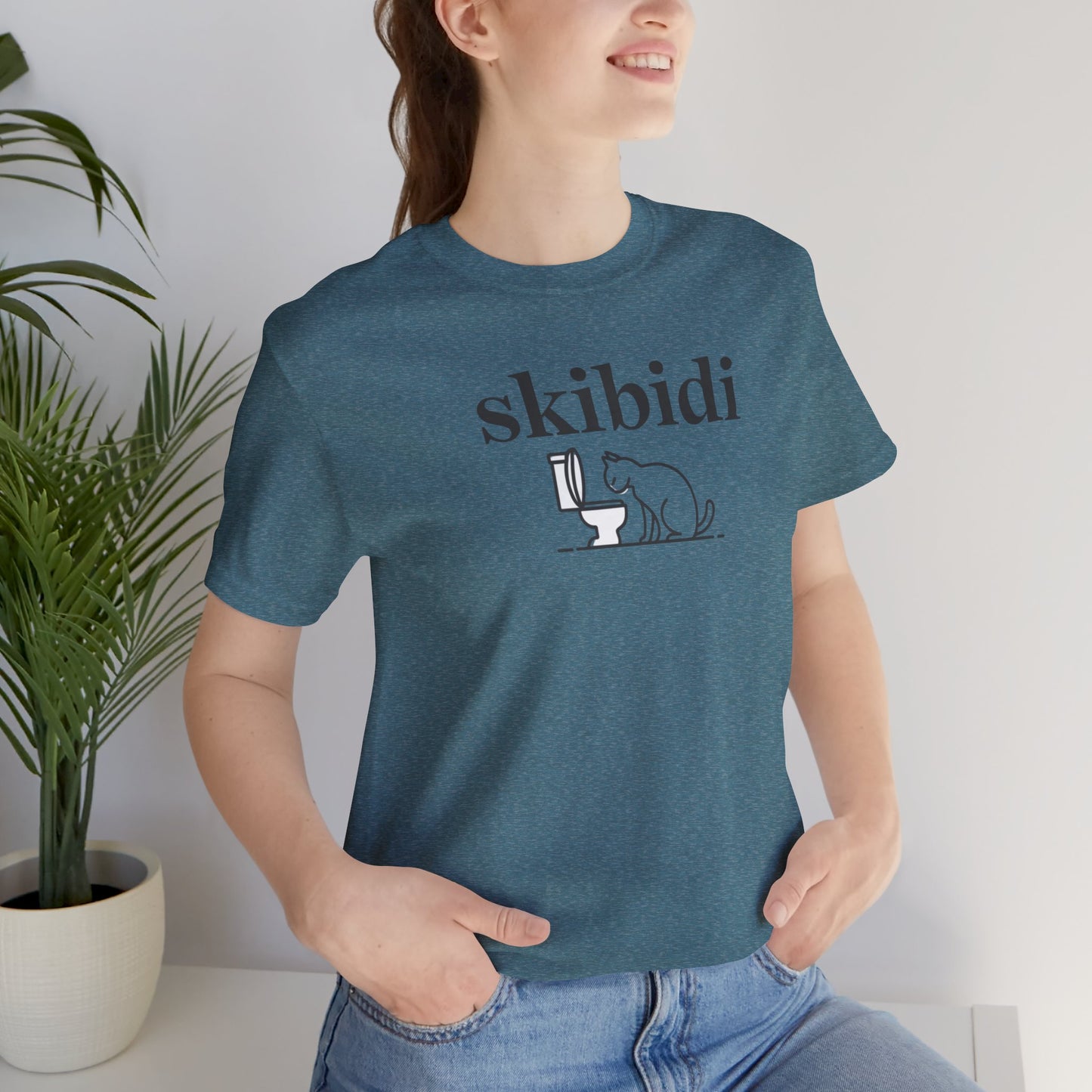 Funny Skibidi Toilet Cat Shirt Turn heads and spark laughter with our hilarious "Skibidi" T-shirt! Featuring a mischievous cat inspecting a toilet, this design is the perfect blend of quirky cat humor and minimalist style. Whether you're a cat lover, meme