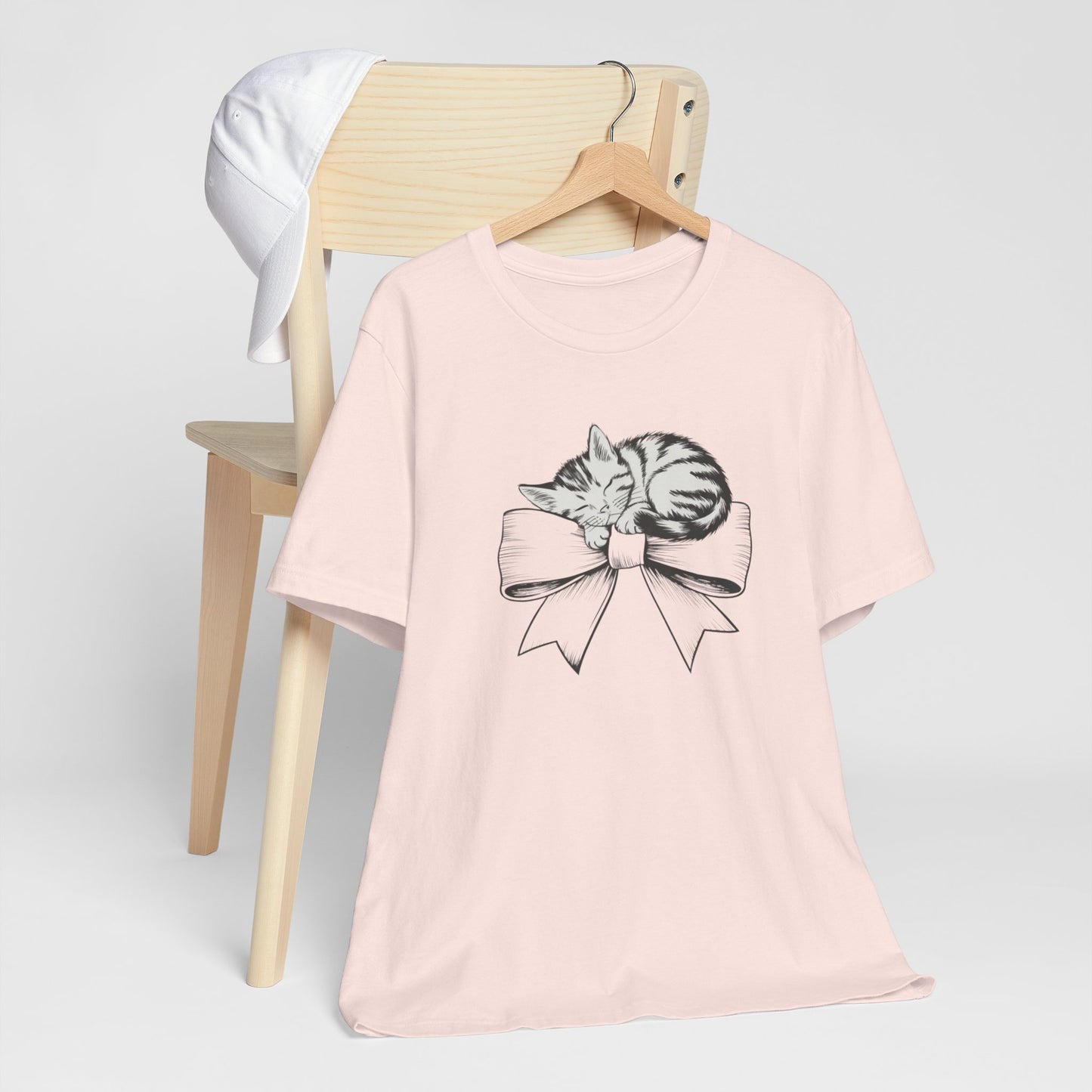 Kitten Bow Valentine's Day Tee This kitten bow Valentines t-shirt exudes a cute and adorable vibe, perfect for celebrating Valentine's Day or showing some love year-round. Product features- Unisex jersey short sleeve tee- Made with 100% lightweight cotton