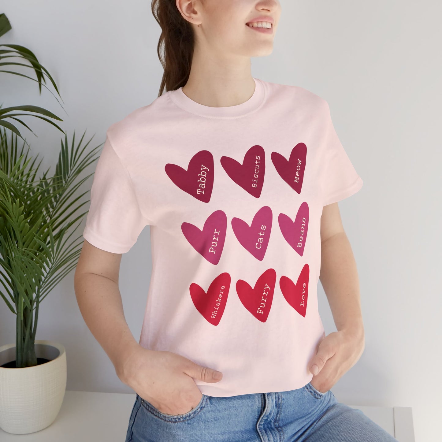 Cat Hearts Valentine’s Day Tshirt This T-Shirt features a cute design of Valentine's Day hearts with various cat types, giving off a playful and festive vibe. It is perfect for cat lovers celebrating Valentine's Day or looking to add a fun touch to their