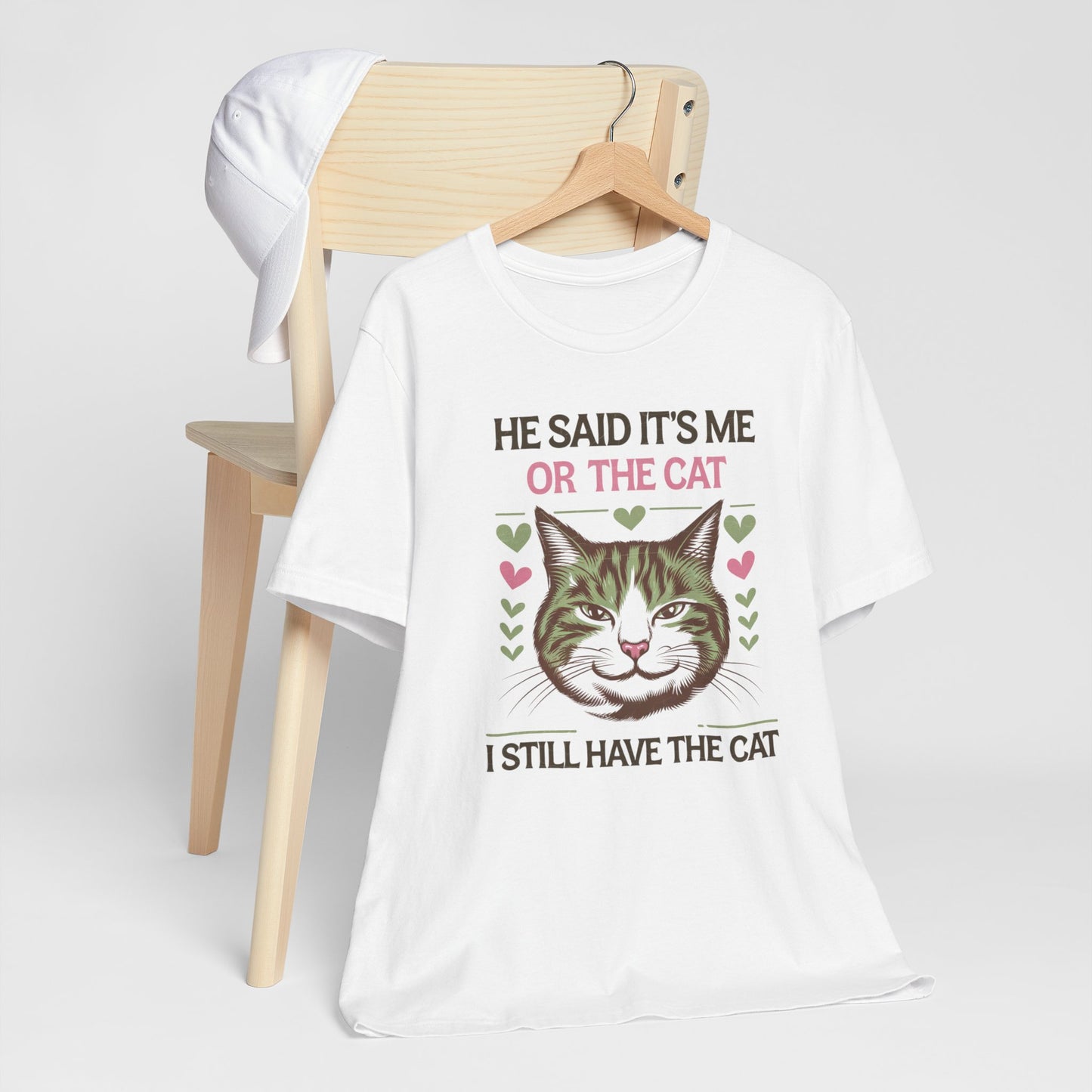 Me or the Cat Valentine's Tee A humorous T-shirt design that expresses the love and preference for cats in a playful way. The tee provides a casual and comfortable vibe, perfect for cat lovers of all ages to wear in everyday situations. Ideal for cat owne