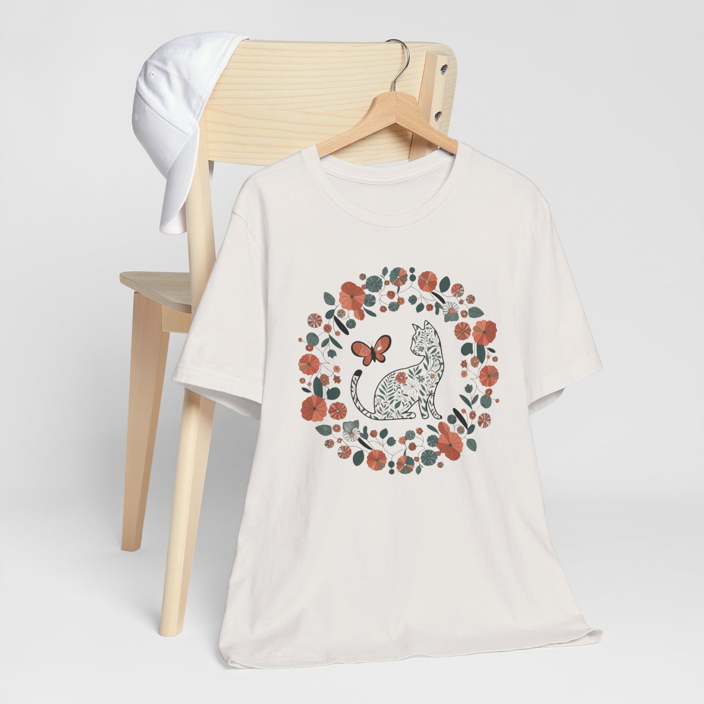 Floral Cat T-shirt with Butterfly This floral cat t-shirt will look great on you for any occassion. Featuring a cat, flowers, and a butterfly, this shirt is sure to catch everyone's eye. The beautiful design will have people asking, "where did you get tha