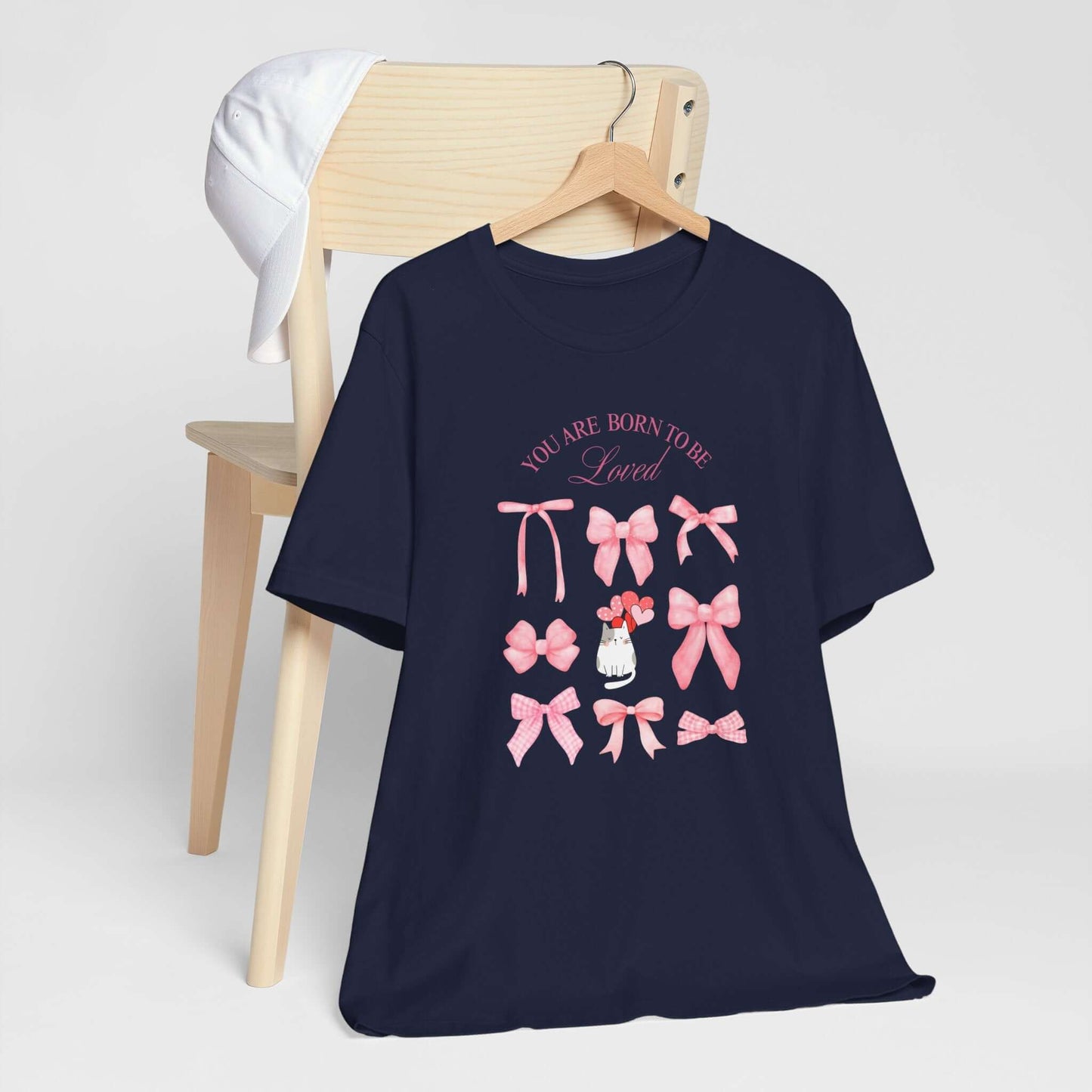 You Are Born To Be Loved Coquette Cat Tee This coquette cat valentines tee radiates a cute and playful vibe, perfect for those who are born to be loved. Product features- Unisex jersey short sleeve tee- Made with 100% lightweight cotton for breathability