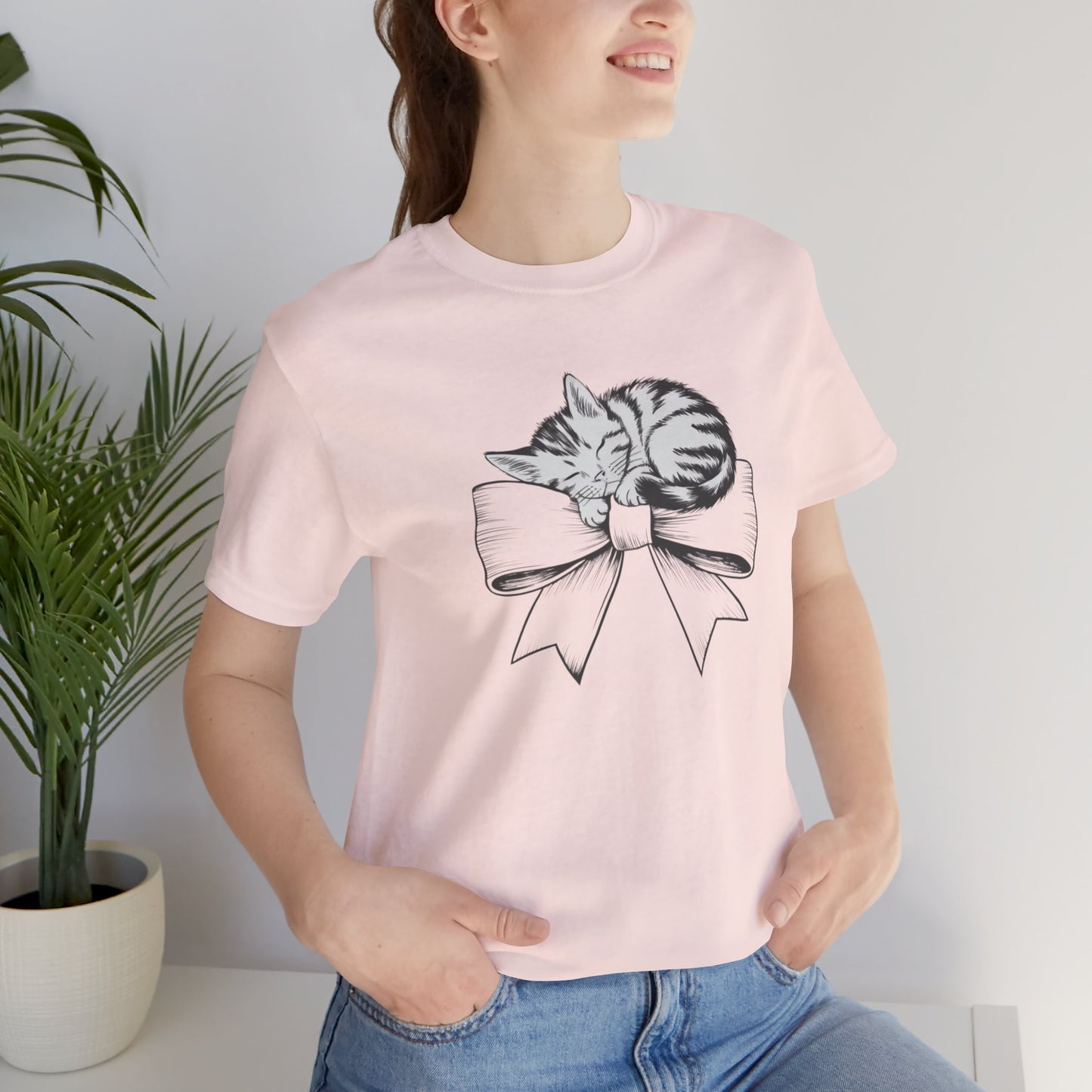 Kitten Bow Valentine's Day Tee This kitten bow Valentines t-shirt exudes a cute and adorable vibe, perfect for celebrating Valentine's Day or showing some love year-round. Product features- Unisex jersey short sleeve tee- Made with 100% lightweight cotton