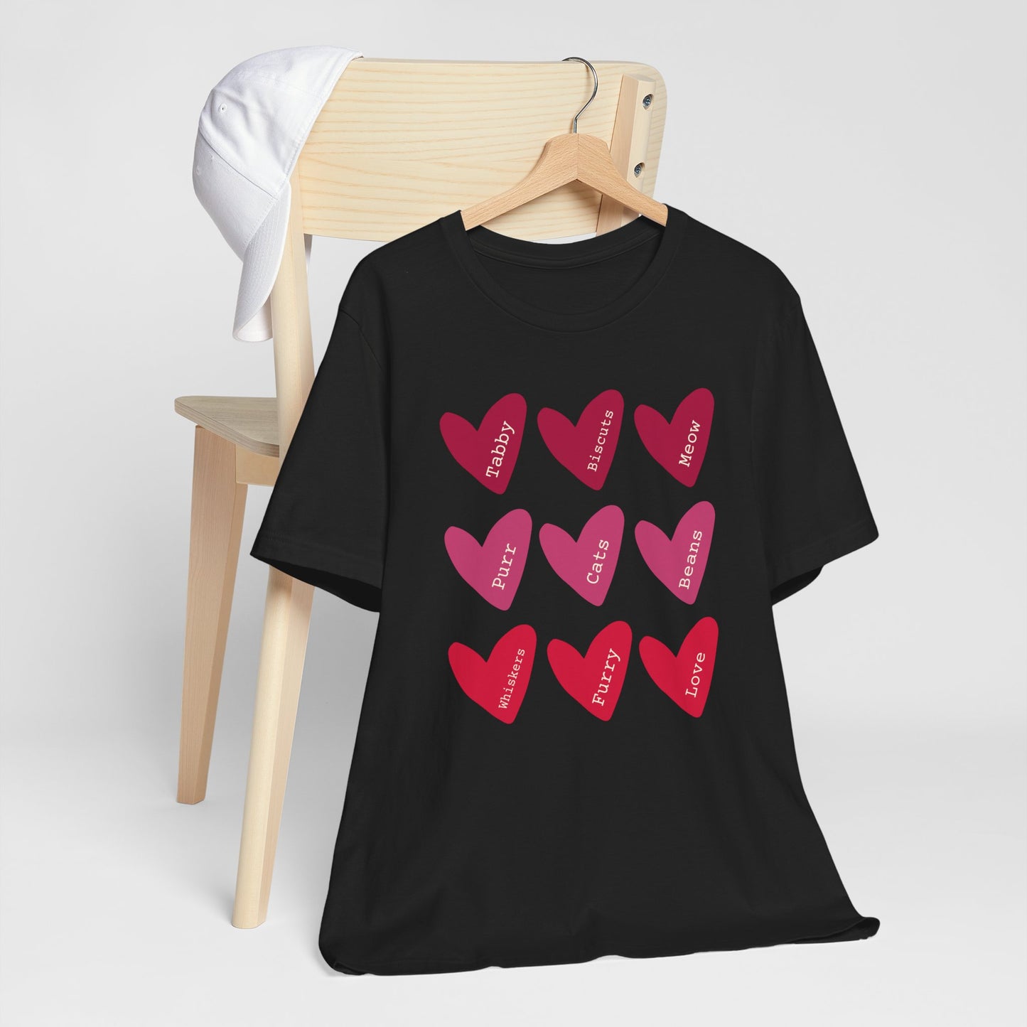 Cat Hearts Valentine’s Day Tshirt This T-Shirt features a cute design of Valentine's Day hearts with various cat types, giving off a playful and festive vibe. It is perfect for cat lovers celebrating Valentine's Day or looking to add a fun touch to their