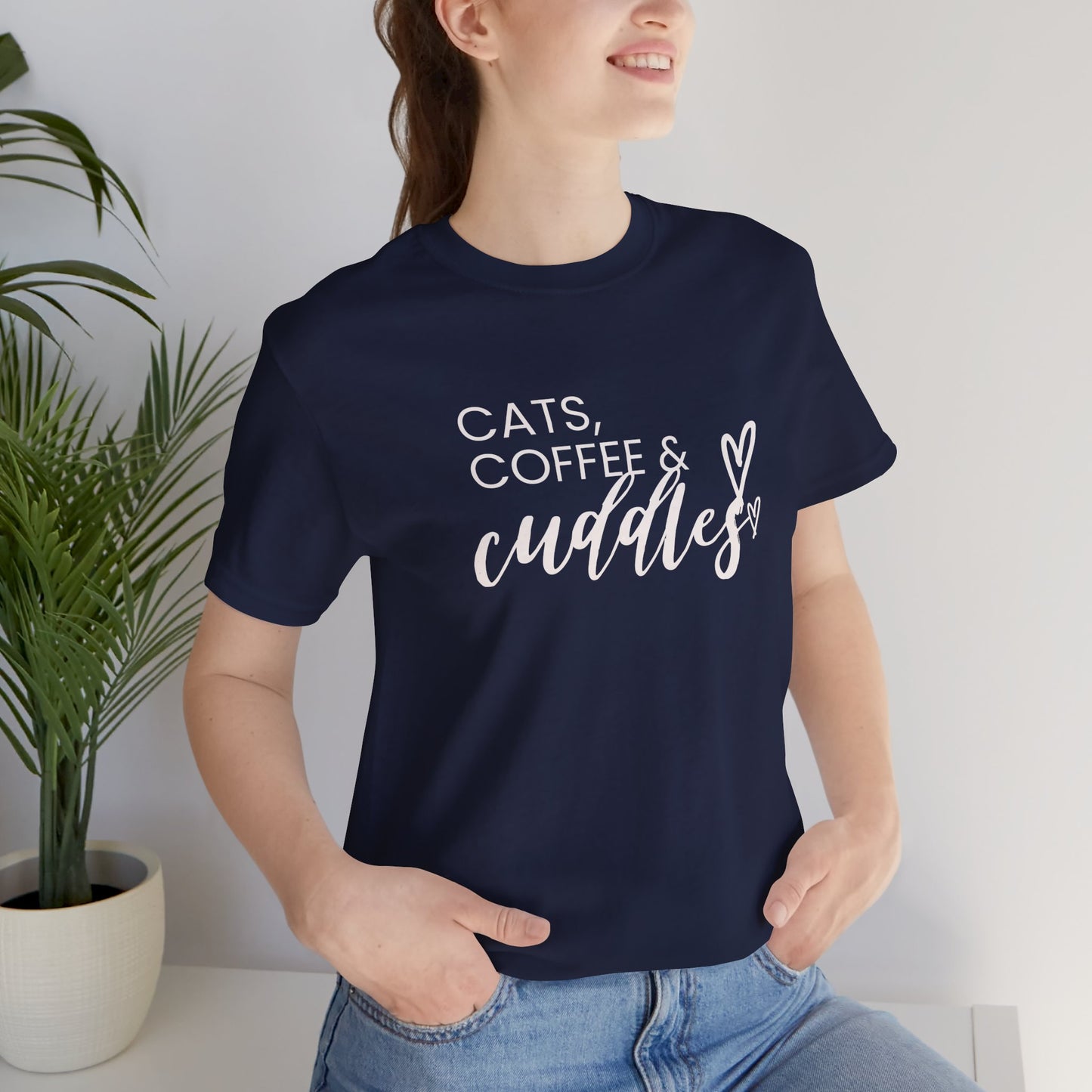 Cats, Coffee, Cuddles Tee Embrace the blissful trifecta of cats, coffee, and cuddles with this delightfully cozy tee. Whether you're curled up on the couch or out and about, this tee lets the world know your priorities - and they're purrfect. Product feat