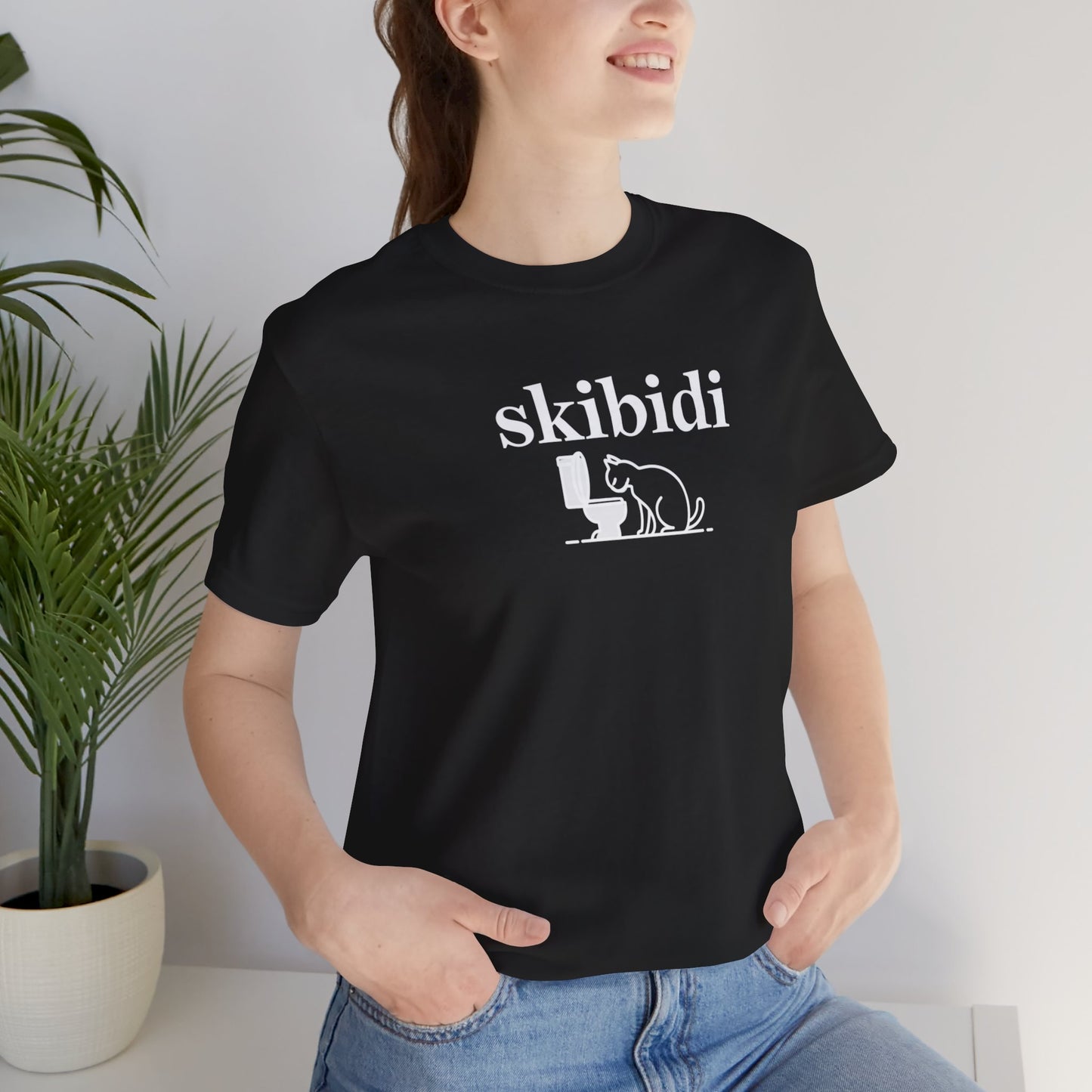 Funny Skibidi Toilet Cat Shirt Turn heads and spark laughter with our hilarious "Skibidi" T-shirt! Featuring a mischievous cat inspecting a toilet, this design is the perfect blend of quirky cat humor and minimalist style. Whether you're a cat lover, meme