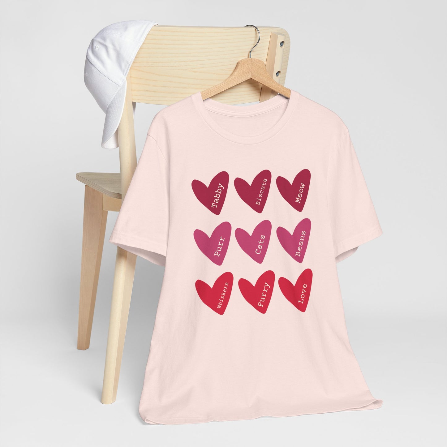 Cat Hearts Valentine’s Day Tshirt This T-Shirt features a cute design of Valentine's Day hearts with various cat types, giving off a playful and festive vibe. It is perfect for cat lovers celebrating Valentine's Day or looking to add a fun touch to their