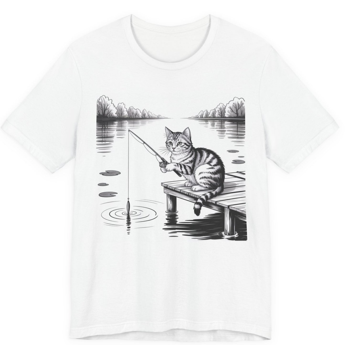White t-shirt with a graphic of a cat fishing on a dock over a lake.