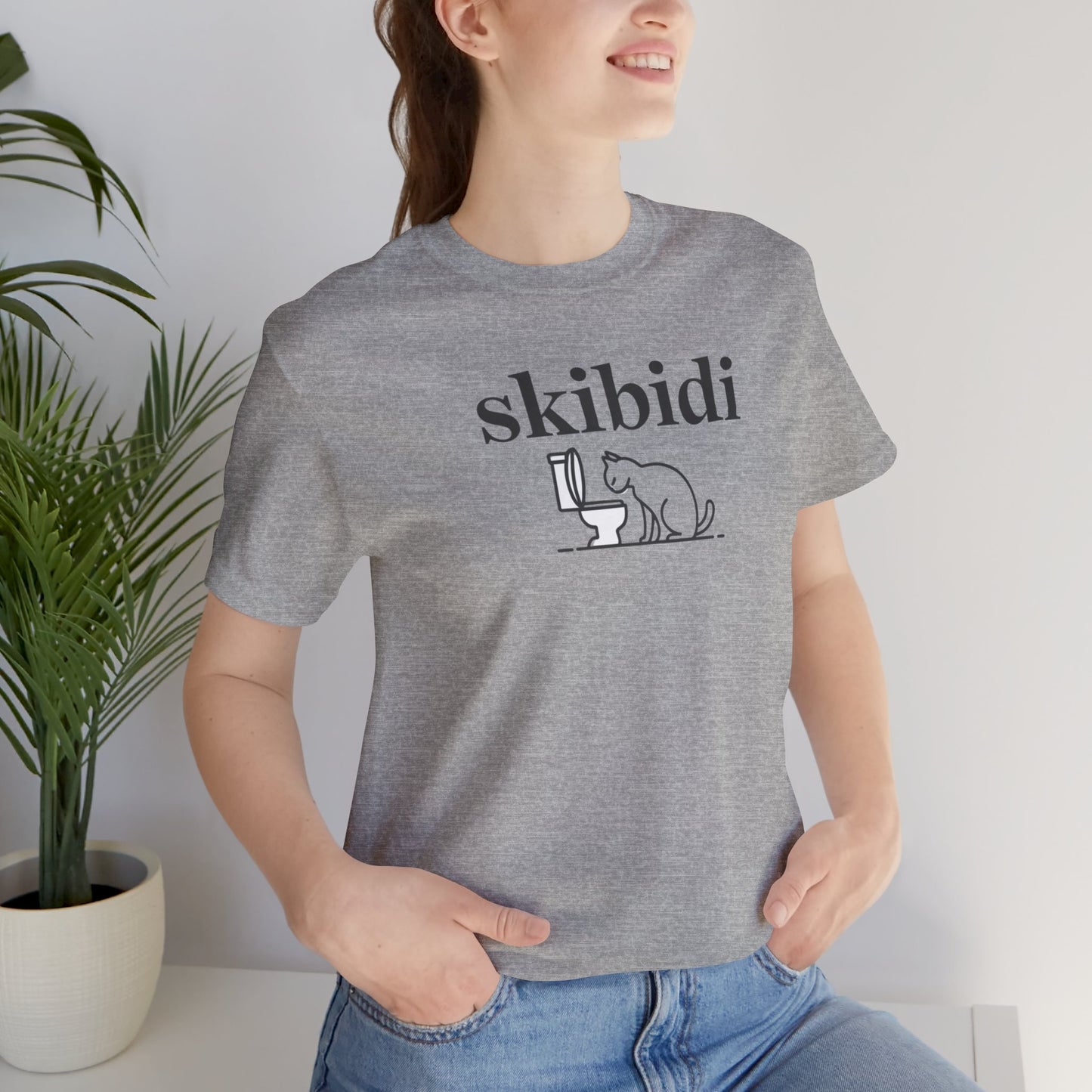 Funny Skibidi Toilet Cat Shirt Turn heads and spark laughter with our hilarious "Skibidi" T-shirt! Featuring a mischievous cat inspecting a toilet, this design is the perfect blend of quirky cat humor and minimalist style. Whether you're a cat lover, meme