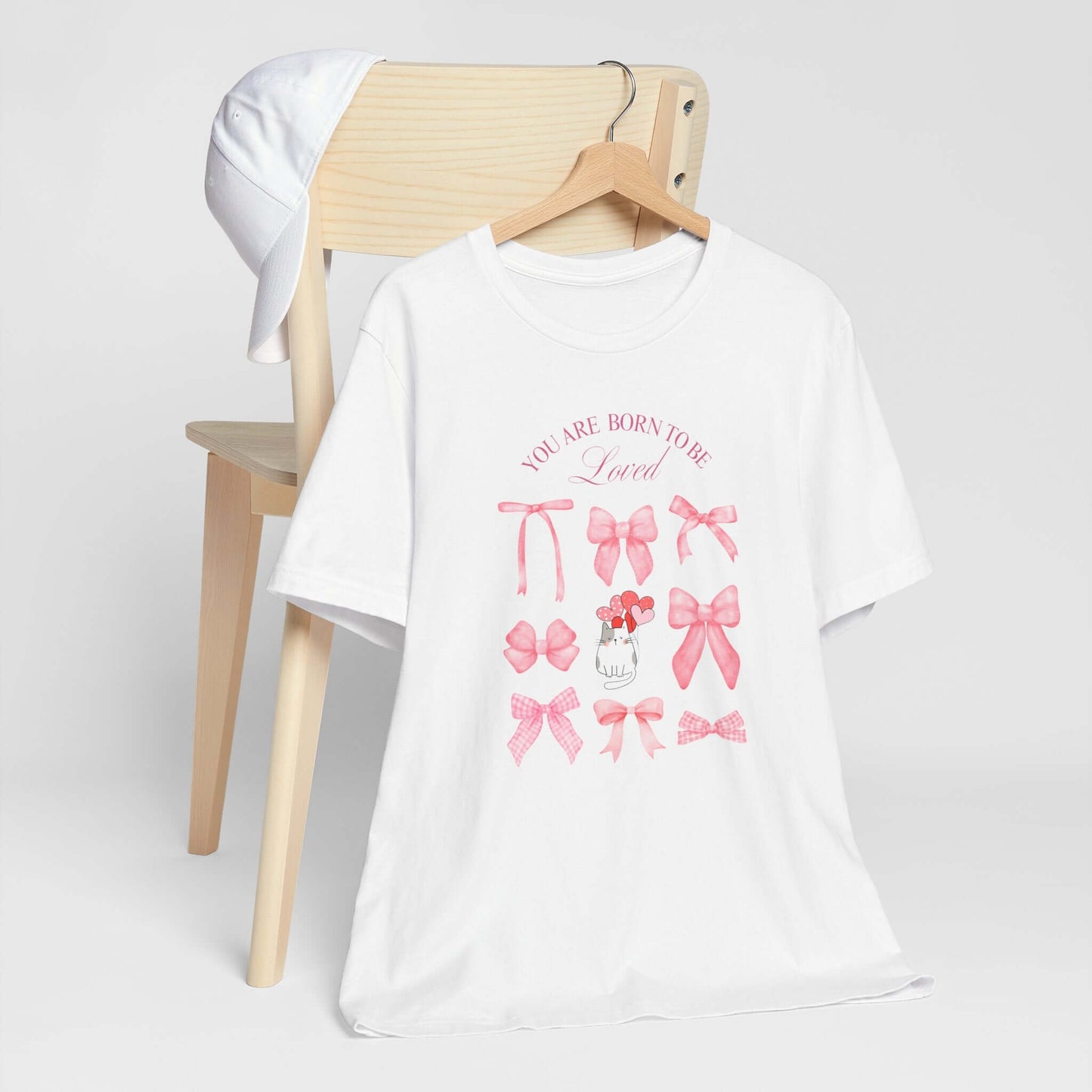 You Are Born To Be Loved Coquette Cat Tee This coquette cat valentines tee radiates a cute and playful vibe, perfect for those who are born to be loved. Product features- Unisex jersey short sleeve tee- Made with 100% lightweight cotton for breathability