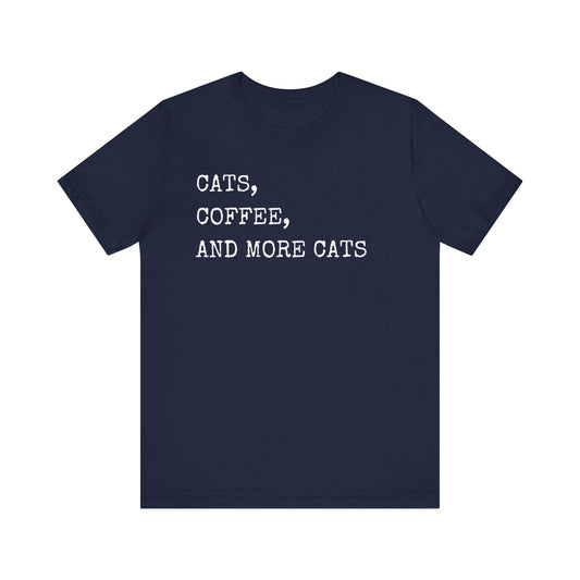 Cats, Coffee, and More Cats Tee If you're the type who can't start the day without a strong cup of coffee and a furry friend by your side, this tee is an absolute must-have. Whether you're a proud cat parent, a casual kitty admirer, or someone who simply