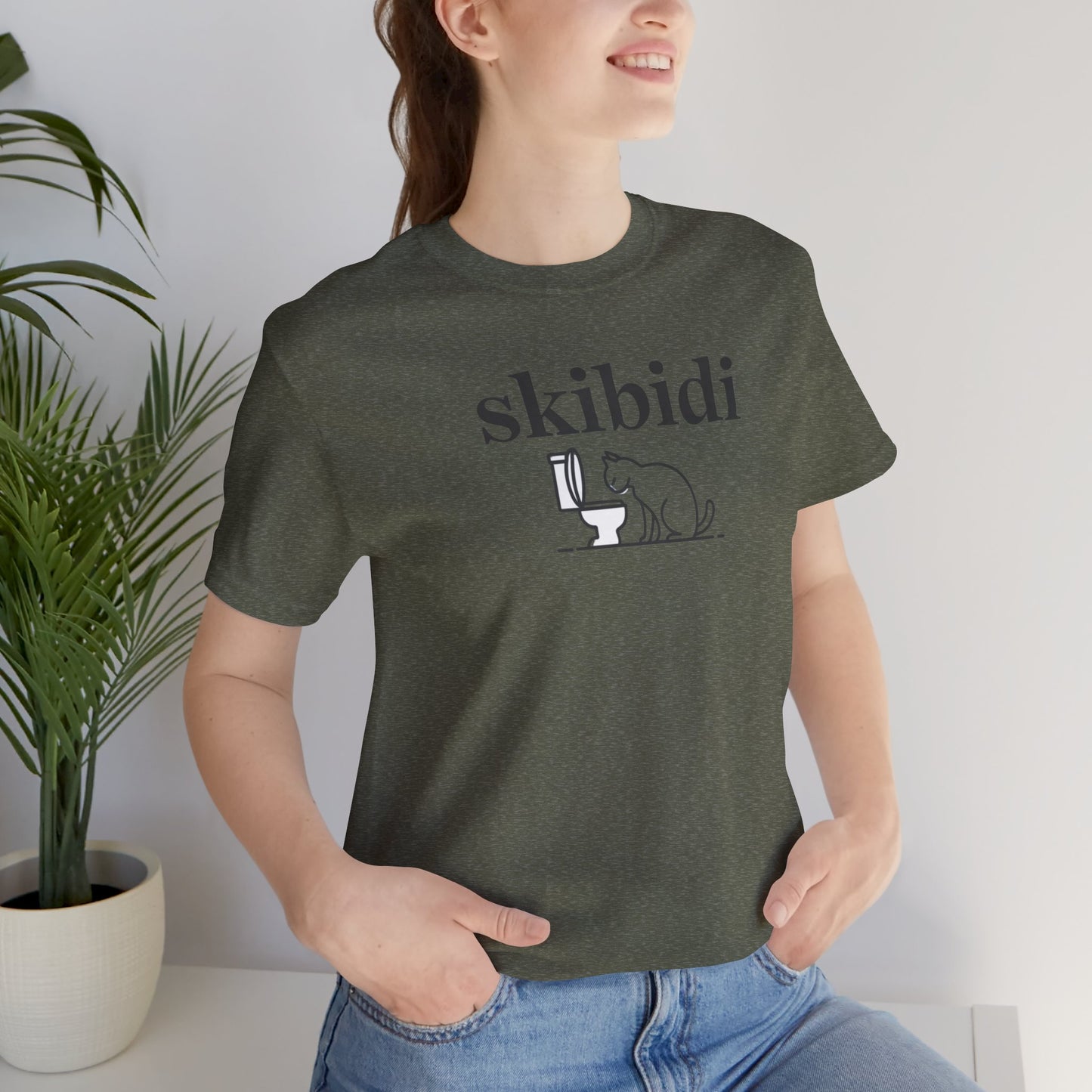 Funny Skibidi Toilet Cat Shirt Turn heads and spark laughter with our hilarious "Skibidi" T-shirt! Featuring a mischievous cat inspecting a toilet, this design is the perfect blend of quirky cat humor and minimalist style. Whether you're a cat lover, meme