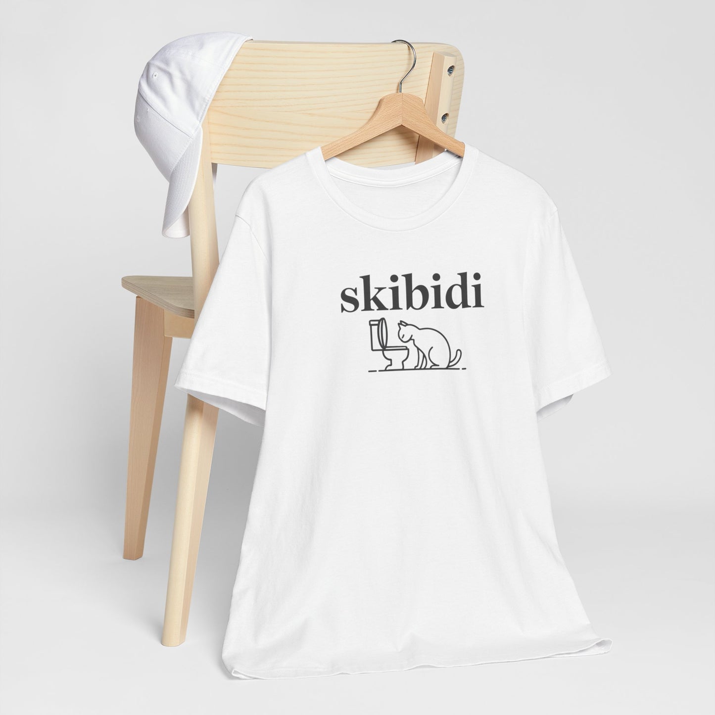 Funny Skibidi Toilet Cat Shirt Turn heads and spark laughter with our hilarious "Skibidi" T-shirt! Featuring a mischievous cat inspecting a toilet, this design is the perfect blend of quirky cat humor and minimalist style. Whether you're a cat lover, meme