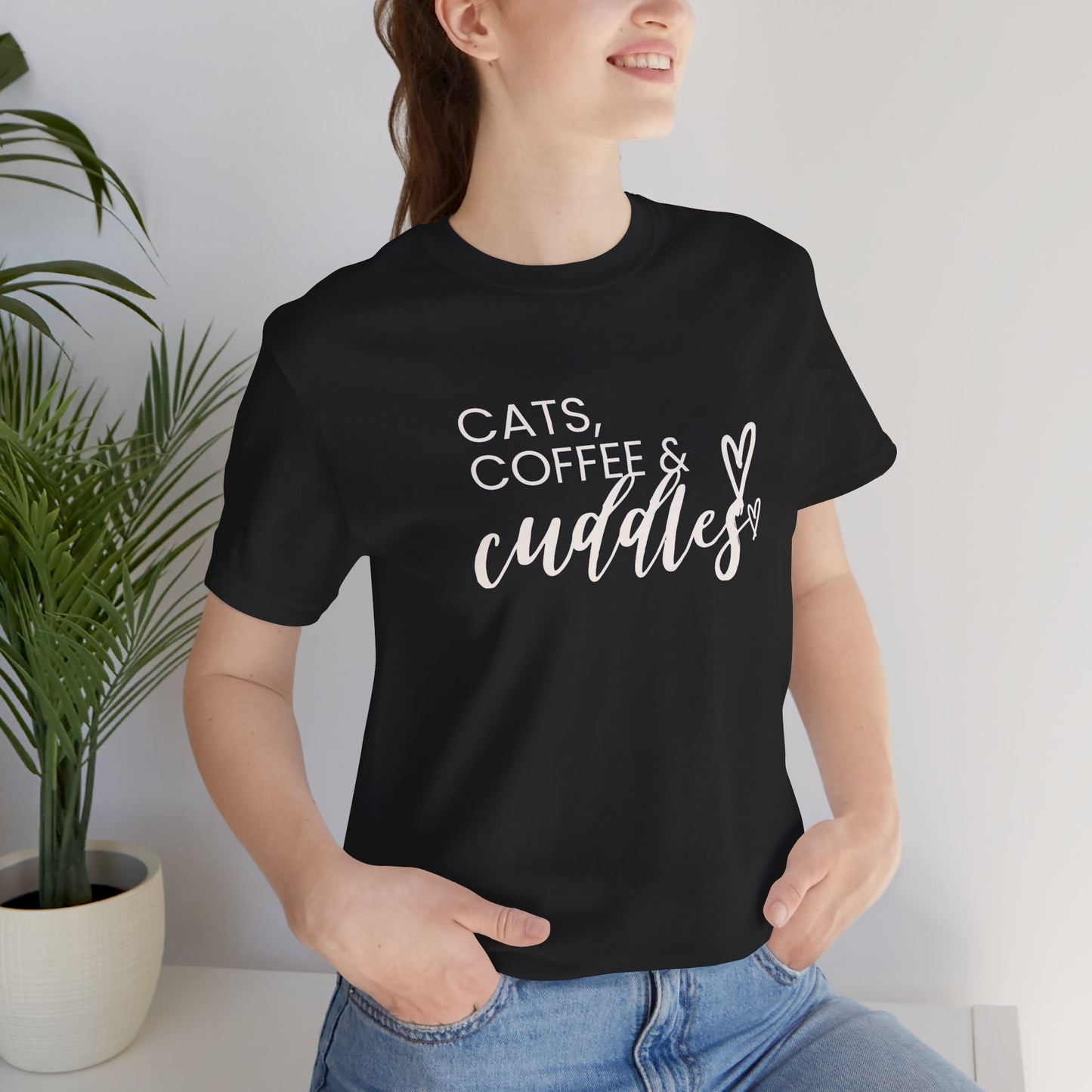 Cats, Coffee, Cuddles Tee Embrace the blissful trifecta of cats, coffee, and cuddles with this delightfully cozy tee. Whether you're curled up on the couch or out and about, this tee lets the world know your priorities - and they're purrfect. Product feat