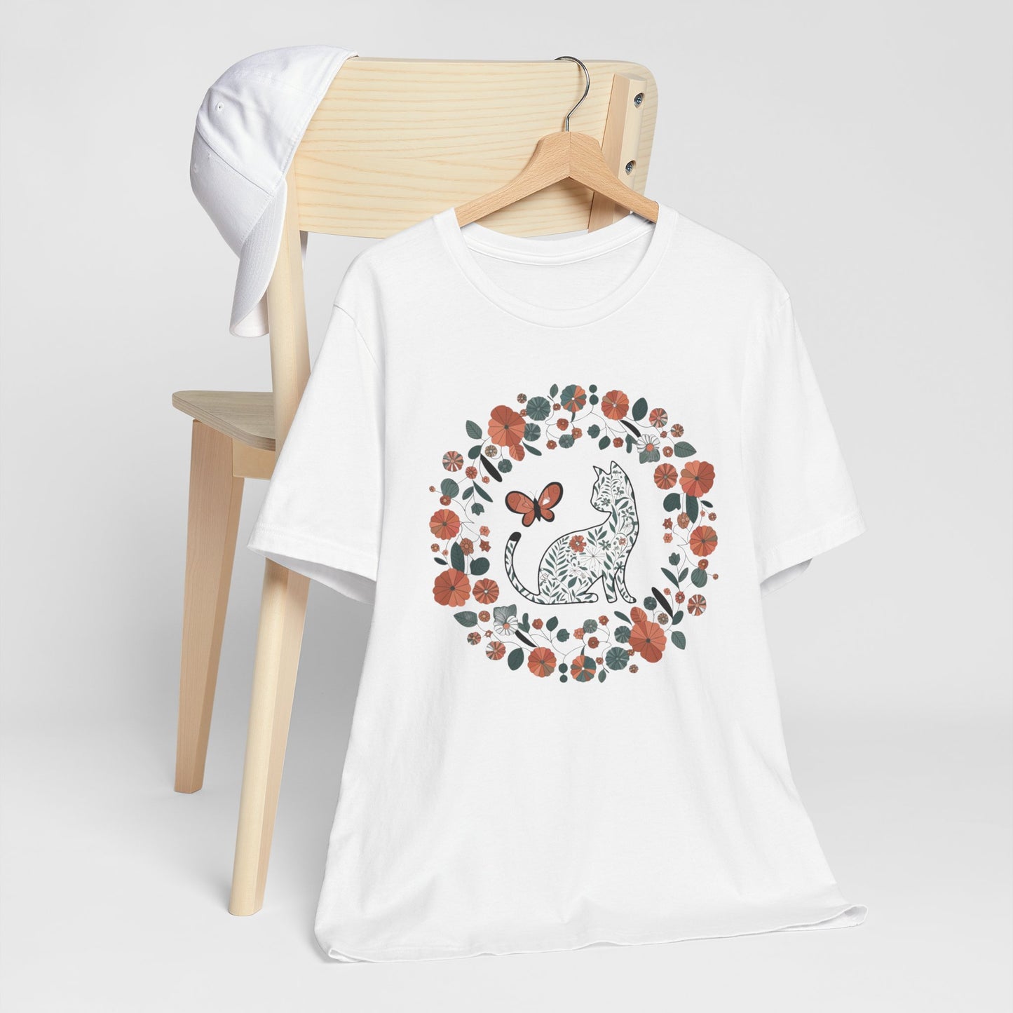 Floral Cat T-shirt with Butterfly This floral cat t-shirt will look great on you for any occassion. Featuring a cat, flowers, and a butterfly, this shirt is sure to catch everyone's eye. The beautiful design will have people asking, "where did you get tha
