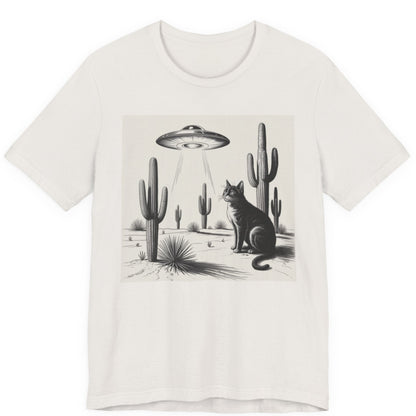 White t-shirt with a graphic of a cat and cacti under a UFO in a desert landscape.