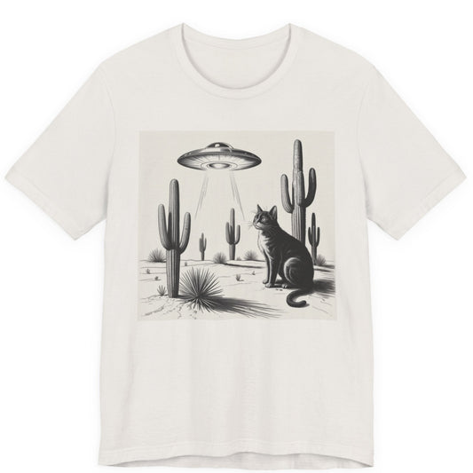 White t-shirt with a graphic of a cat and cacti under a UFO in a desert landscape.