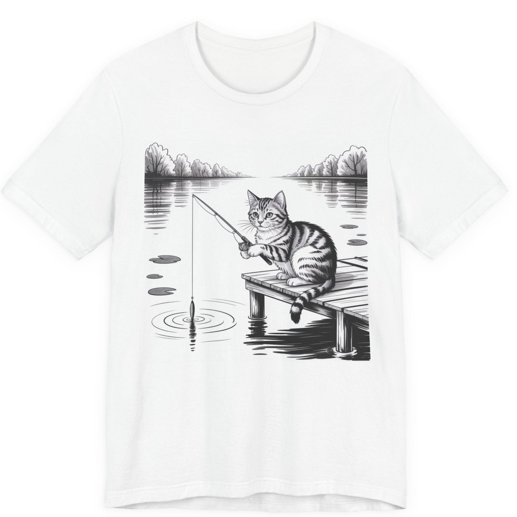 White t-shirt with a graphic of a cat fishing on a dock over a lake.