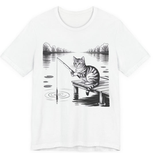 White t-shirt with a graphic of a cat fishing on a dock over a lake.