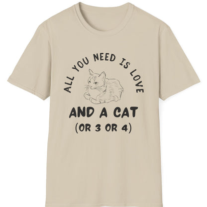 Beige t-shirt with a graphic of a cat and text that says all you need is love and a cat or 3 or 4