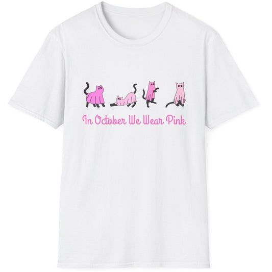 White t-shirt with pink cat illustrations and text on a white background. text says in october we wear pink. symbolizes for breast cancer awareness